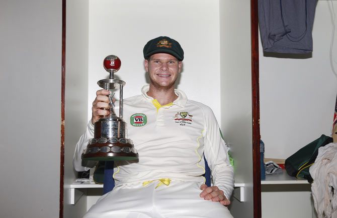 Steve Smith of Australia poses with the Frank Worrell Trophy in the change rooms after winning the second Test against West Indies at Sabina Park on Sunday