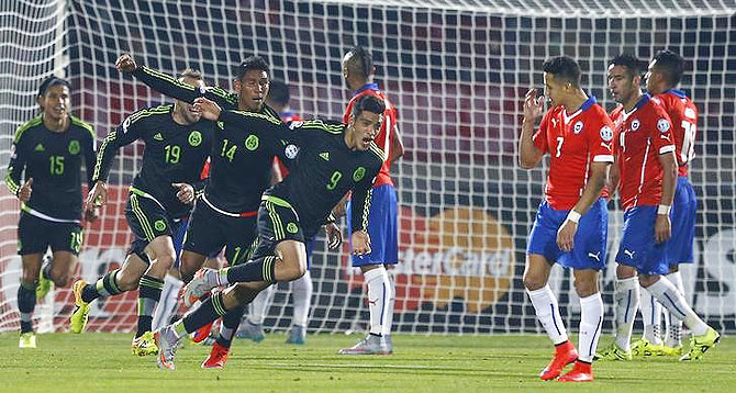 Mexico's Raul Jimenez (right) celebrates after scoring against Chile