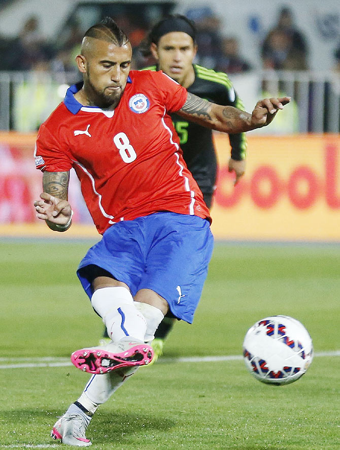 Chile's Arturo Vidal kicks to score against Mexico