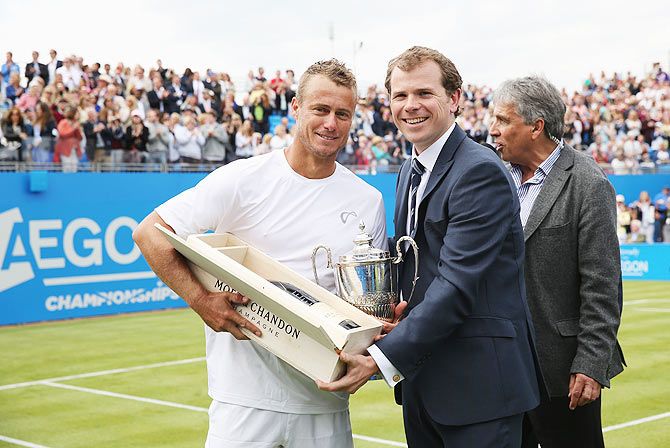 Australia's Lleyton Hewitt poses with Tournament Director Stephen Farrow after his last match at Queen's Club having lost to South Africa's Kevin Anderson in his men's singles first round match on Monday
