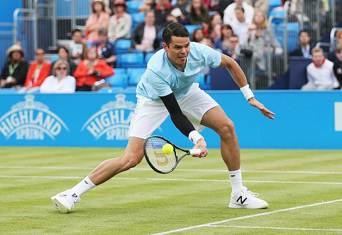 Canada's Milos Raonic plays a volleys in his singles first round match against Great Britain's James Ward