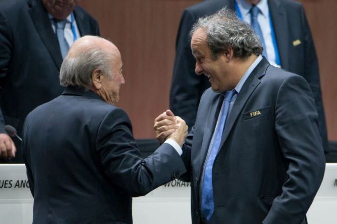 FIFA President Joseph S Blatter (L) shakes hands with UEFA president Michel Platini during the 65th FIFA Congress at Hallenstadion