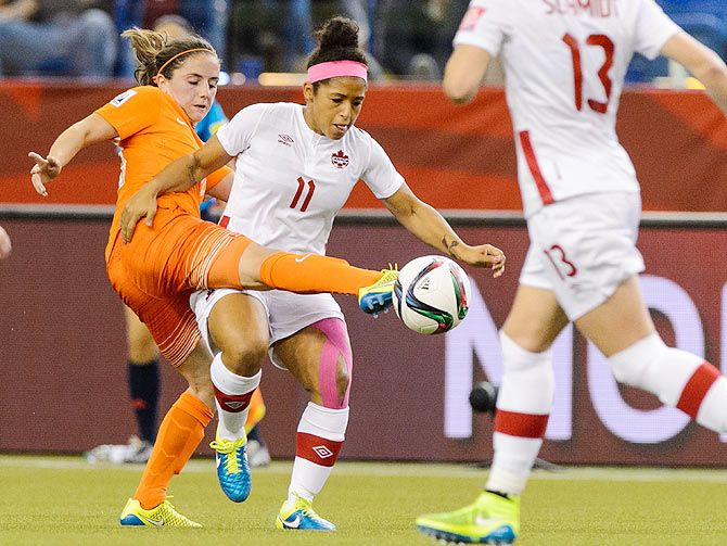 The Netherlands's Danielle Van De Donk battles for the ball with Canada's Desiree Scott