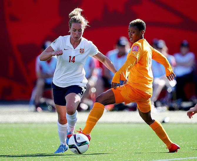 Norway's Ingrid Schjelderup is intercepted by Ivory Coast's Ines Nrehy during their match at Moncton Stadium in Moncton, Canada on Monday