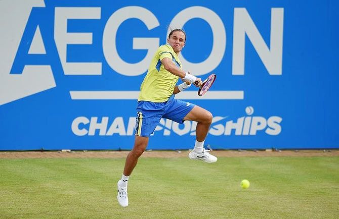 Ukraine's Alexandr Dolgopolov plays a return against Rafael Nadal