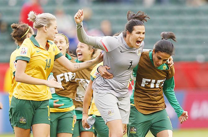 Australia players Alanna Kennedy, Lydia Williams and Leena Khamis celebrate after their match against Sweden at Commonwealth Stadium in Edmonton, Alberta, Canada, on Tuesday