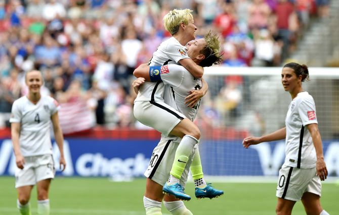 United States' Abby Wambach (right) celebrates with teammate Megan Rapinoe after scoring to top US goal record list