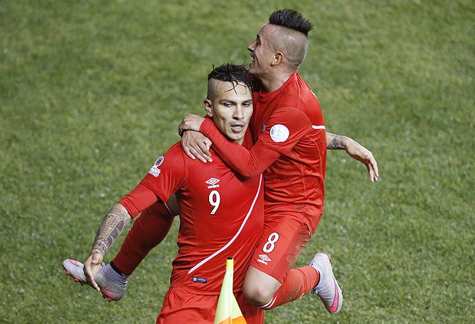 Peru's Paolo Guerrero (left) celebrates his third goal against Bolivia with teammate Christian Cueva during their 2015 Copa America quarter-final match at Estadio Municipal Bicentenario German Becker in Temuco, Chile, on Thursday