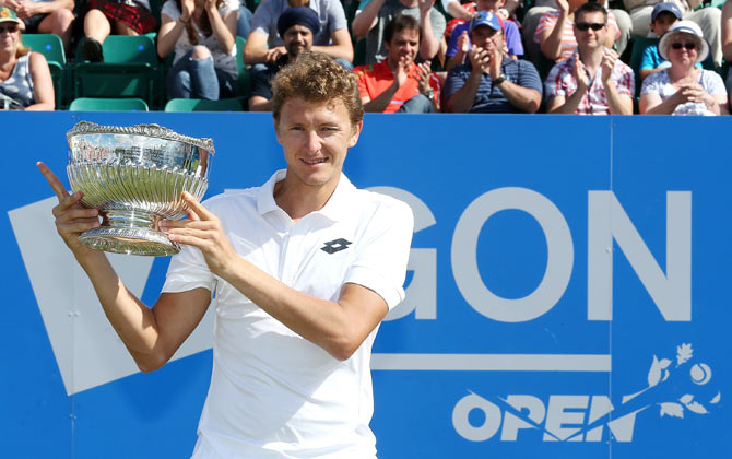 Uzbekistan's Denis Istomin poses with the trophy after beating American Sam Querrey to win the men's singles title at the Aegon Open at Nottingham Tennis Centre on Saturday