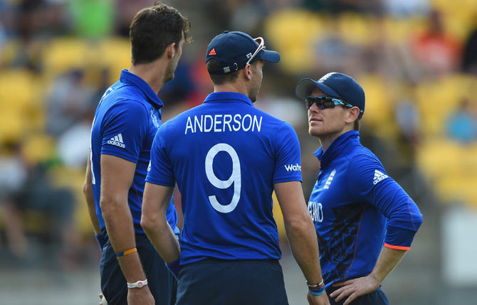 England captain Eoin Morgan (right) speaks to his fast bowlers James Anderson (centre) and Steve Finn