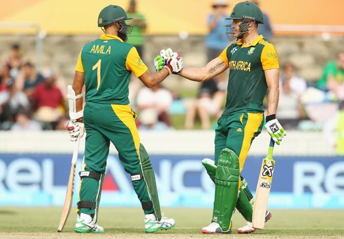 Hashim Amla and Faf du Plessis of South Africa celebrate their 200 run partnership during their World Cup match against Ireland at Manuka Oval in Canberra on Tuesday