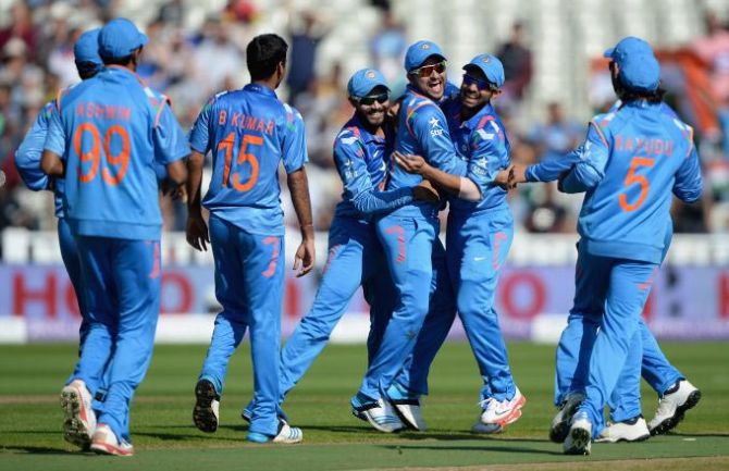 The Indian team celebrates after claiming a wicket