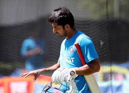 Mohit Sharma examines his hand after being hit during Thursday's nets session in Perth