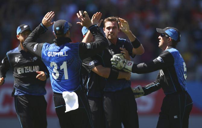 Tim Southee of New Zealand celebrates with teammates after taking a wicket