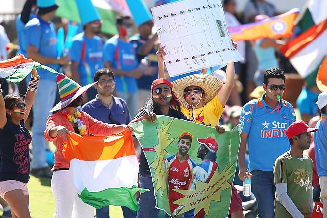 Indian fans celebrate the wicket of Dwayne Smith of the West Indies