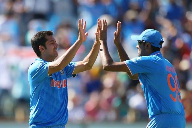 Mohit Sharma and Ravichandran Ashwin celebrate Chris Gayle's wicket, March 6, 2015.
