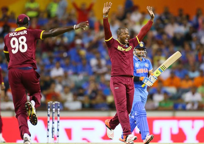 West Indies' Dwayne Smith celebrates the wicket of India's Suresh Raina during their World Cup match at the WACA in Perth on Friday