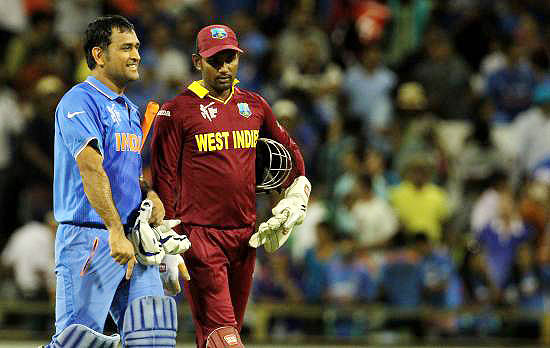 Mahendra Singh Dhoni and Denesh Ramdin walk off the field after the match
