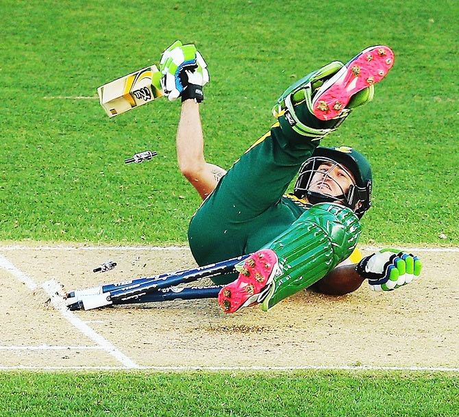 Francois du Plessis of South Africa crashes into the wickets
