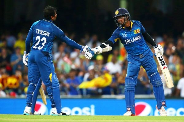 Sri Lanka's Tillakaratne Dilshan congratulates Kumar Sangakkara after he passed the milestone of 14000 One-Day International runs against Australia in Sydney