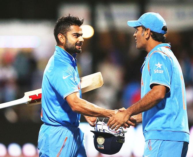 Virat Kohli of India is congratulated by Mahendra Singh Dhoni