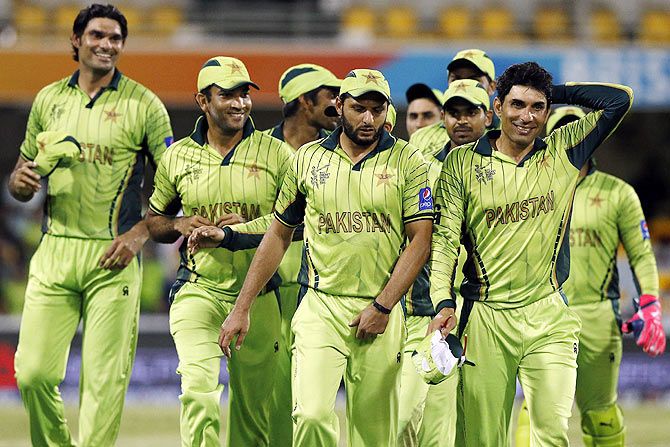 Pakistan's captain Misbah-ul-Haq (right) leads his teammates off the field