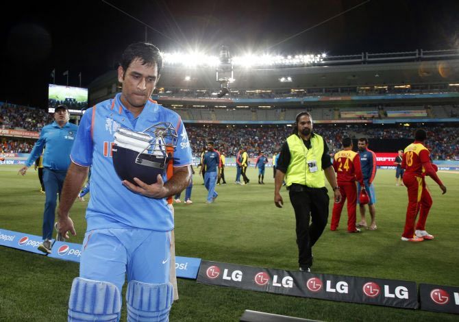 India's captain Mahendra Singh Dhoni leaves the field
