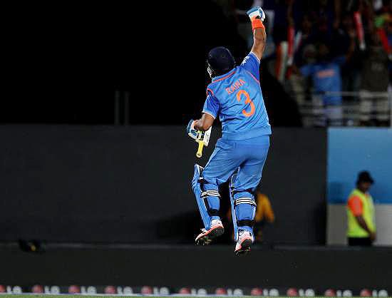 India's Suresh Raina celebrates after scoring a century against Zimbabwe during their ICC World Cup Pool B match at the Eden Park stadium in Auckland on Saturday