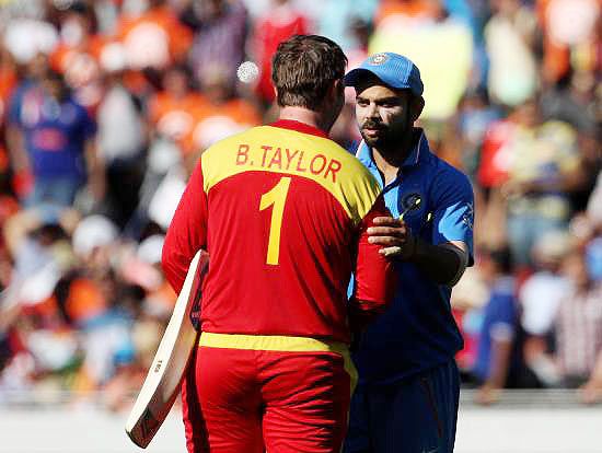India's Virat Kohli congratulates Zimbabwe's Brendan Taylor on completing his century 