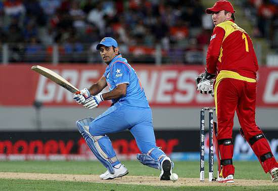 India player Mahendra Singh Dhoni bats as Zimbabwe's Brendan Taylor looks on