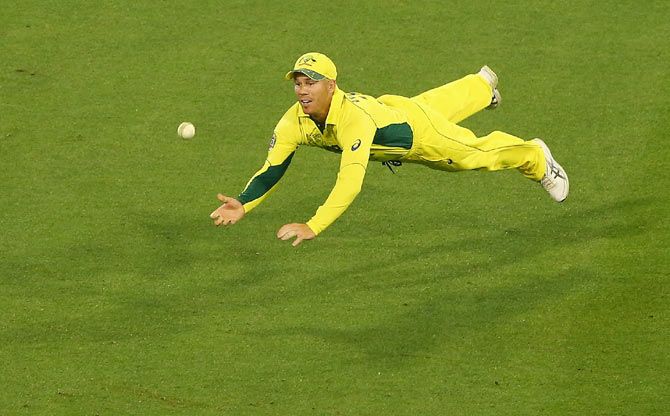 David Warner of Australia dives in an attempt to catch out James Anderson of England during their 2015 ICC World Cup match at Melbourne Cricket Ground 