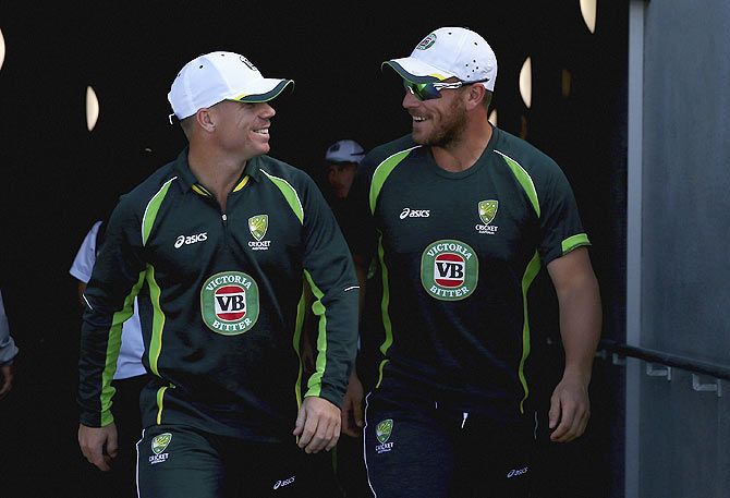 David Warner and Aaron Finch of Australia arrive for a nets session
