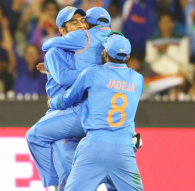 Mahendra Singh Dhoni of India is congratulated by Sureh Raina 