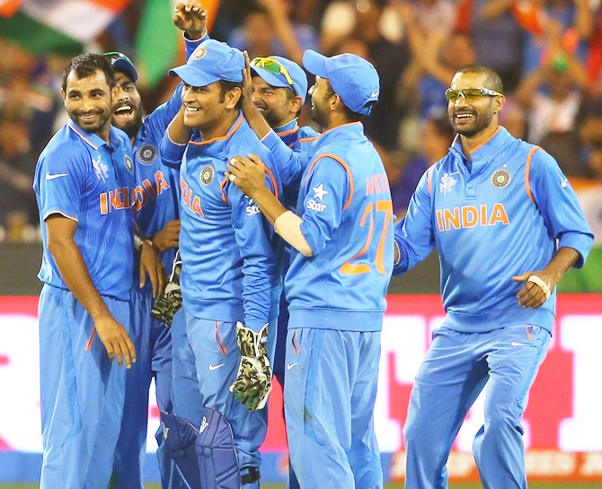 M S Dhoni congratulated by his team-mates after his incredible catch to get rid of Soumya Sarkar. Photograph: Quinn Rooney/Getty Images