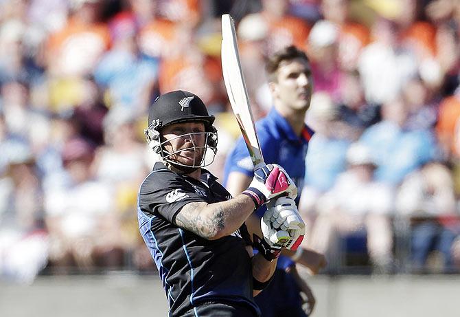 New Zealand's captain Brendon McCullum (left) hits a boundary 