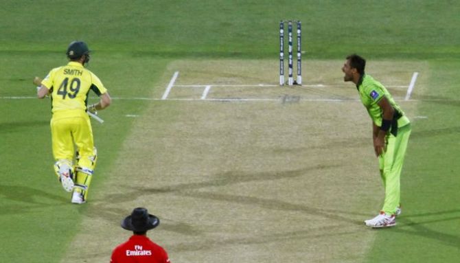 Australia's Steve Smith (left) runs as Pakistan's bowler Wahab Riaz screams