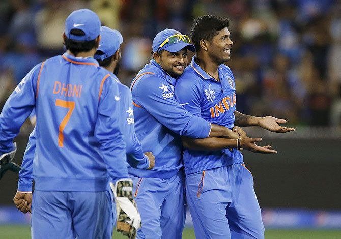 India's Suresh Raina (centre) celebrates with teammate Umesh Yadav after dismissing Bangladesh batsman Mushfiqur Rahim 