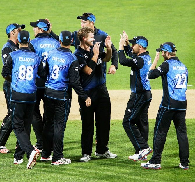 Corey Anderson of New Zealand is congratulated by teammates