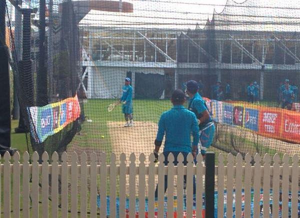 Indian captain Mahendra Singh Dhoni serves down tennis balls at Suresh Raina during a nets session at the Sydney Cricket Ground on Monday