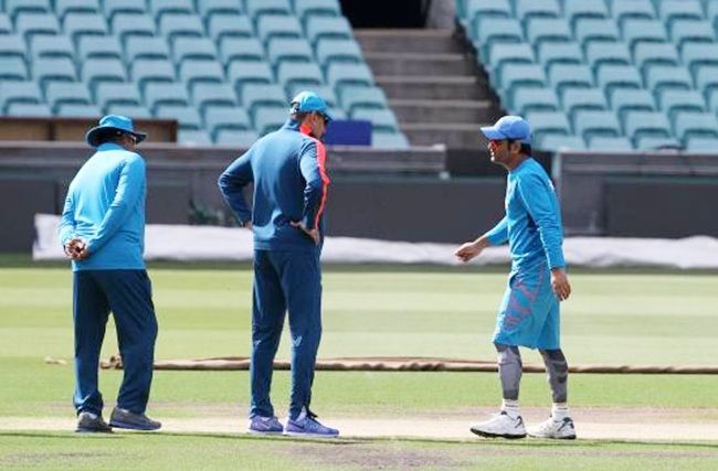 From left, India coach Duncan Fletcher, captain Mahendra Singh Dhoni, right, and Indian team director Ravi Shastri check the pitch
