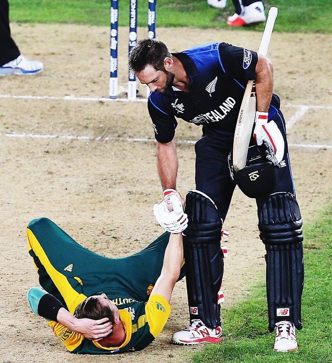 Grant Elliott, who scored a six off the penultimate delivery to win the match for New Zealand, helps South Africa pacer Dale Steyn off the ground at the end of their 2015 ICC World Cup semi-final on March 24