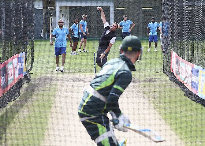 Australia spin legend Shane Warne bowls to Michael Clarke during a nets session at Sydney Cricket Ground on Wednesday