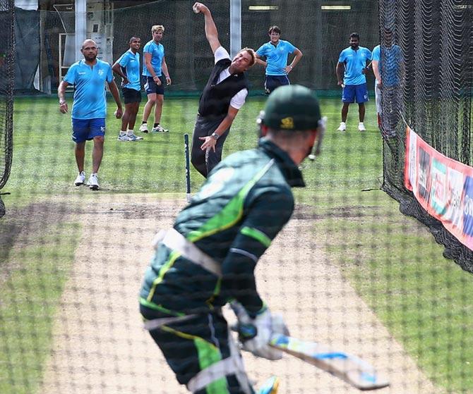 Shane Warne bowls to Michael Clarke of Australia