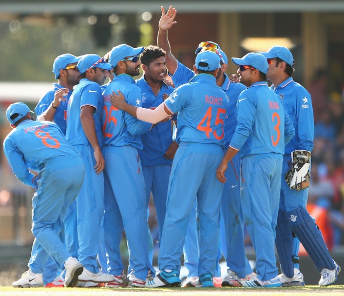 Team-mates congratulate Umesh Yadav after the Vidarbha lad dismissed Aaron Finch. Photograph: Cameron Spencer/Getty Images