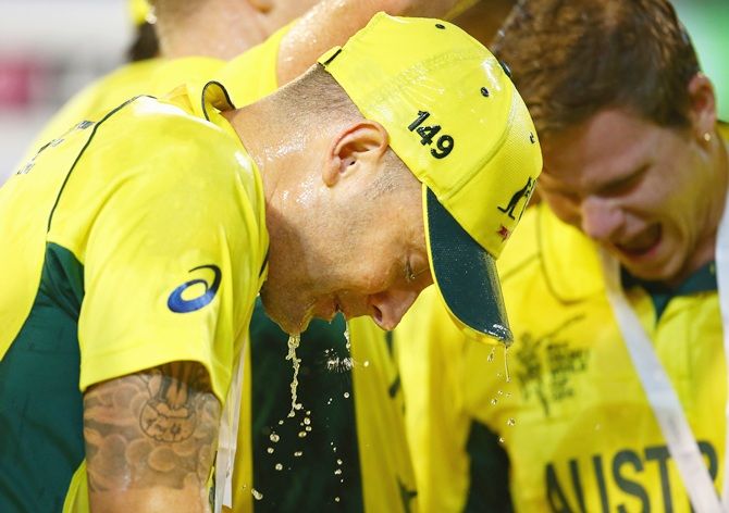 Australia's Michael Clarke is sprayed with champagne by his teammates as they celebrate winning the 2015 ICC Cricket World Cup final at the MCG on Sunday
