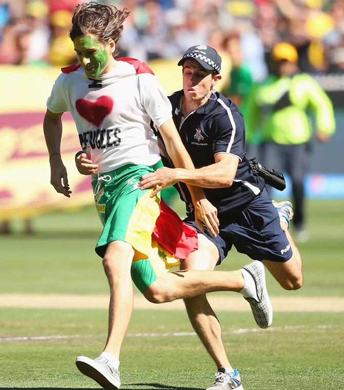 A pitch invader is tackled by police 