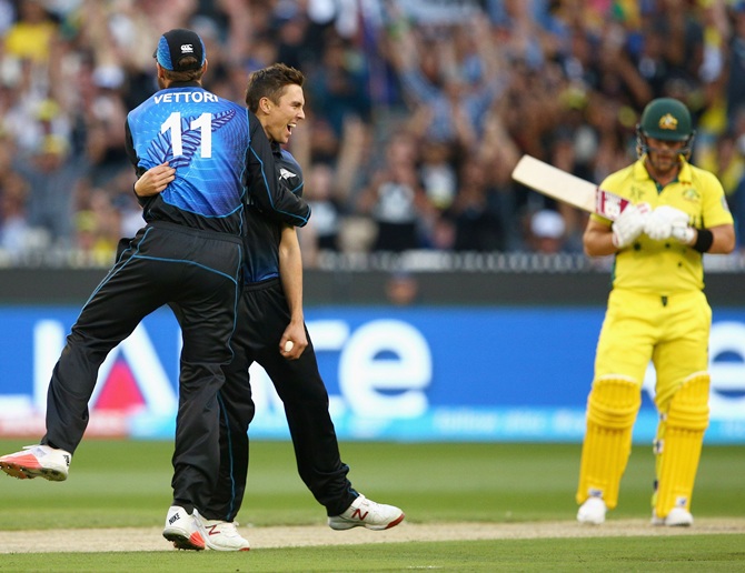 Trent Boult celebrates with Daniel Vettori after dismissing Aaron Finch. Photograph: Cameron Spencer/Getty Images