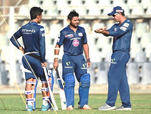 Mumbai Indians players Unmukt Chand and Parthiv Patel with the team's head coach Ricky Ponting during a practice session