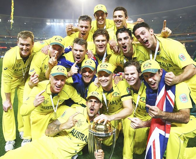 Australian captain Michael Clarke is presented the World Cup trophy