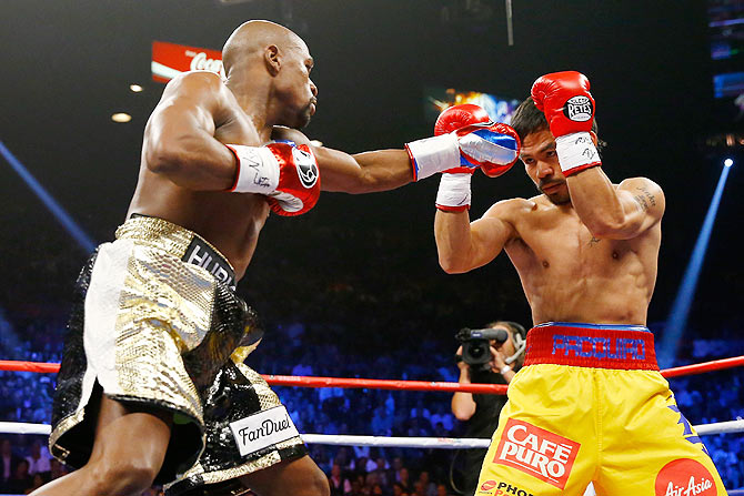Floyd Mayweather Jr. throws a left at Manny Pacquiao during their welterweight unification championship bout at MGM Grand Garden Arena in Las Vegas, Nevada, on Saturday